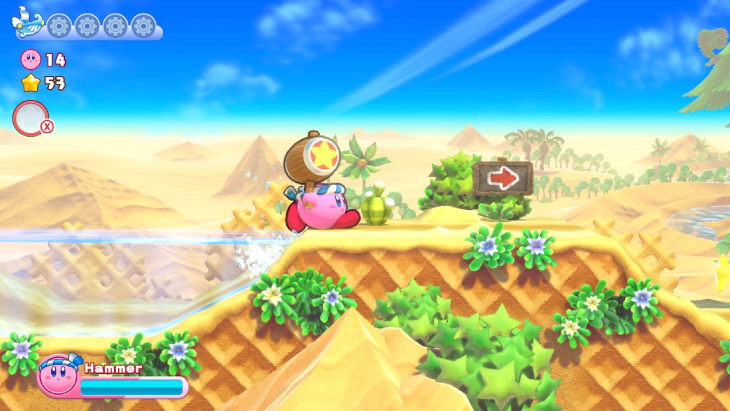 Playing a beach level with the hammer Copy Ability in Kirby's Return to Dream Land Deluxe